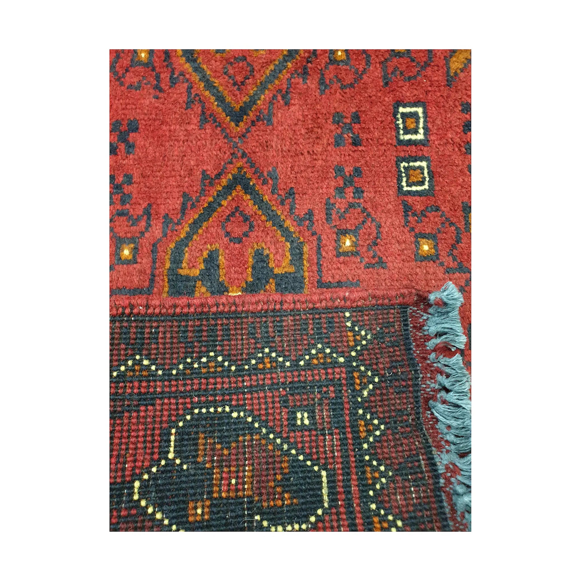 Folded corner reverse-weave detail of Afghan Khal Mohammadi hand-knotted wool rug showing back structure, border pattern, fringe and weave