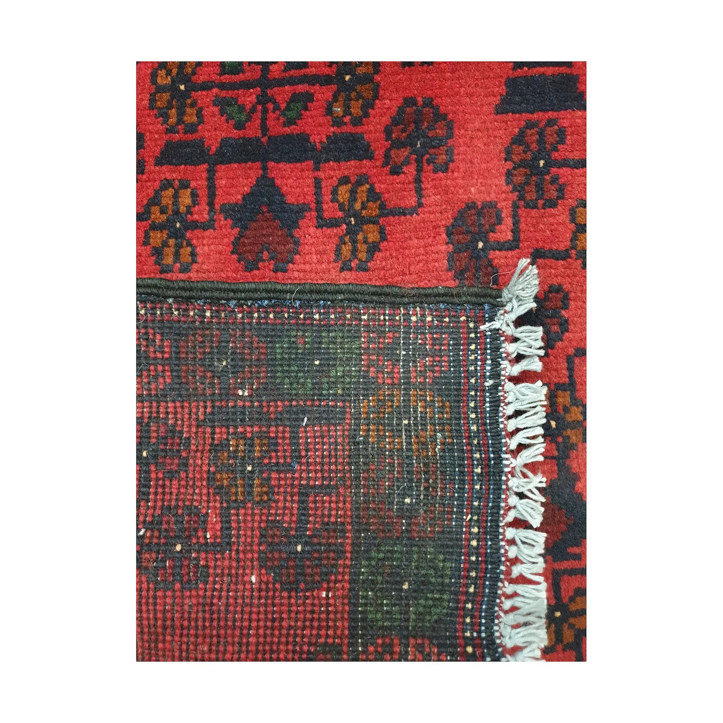 Folded corner reverse-weave detail of Afghan Khal Mohammadi hand-knotted wool rug showing back structure, border pattern, fringe and weave