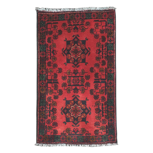 Full view of Afghan Khal Mohammadi hand-knotted wool rug with deep red field, central geometric medallion and patterned border, 99 x 52 cm