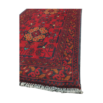Angled corner and fringe view of Afghan Khal Mohammadi wool rug showing deep red field, dark border detail and light fringe