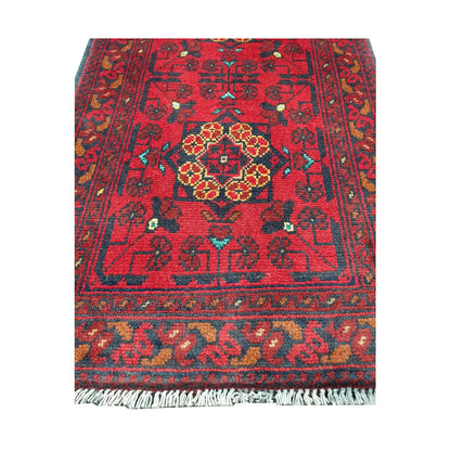 Central medallion and field detail of Afghan Khal Mohammadi hand-knotted rug showing red ground, dark motifs and warm ochre accents