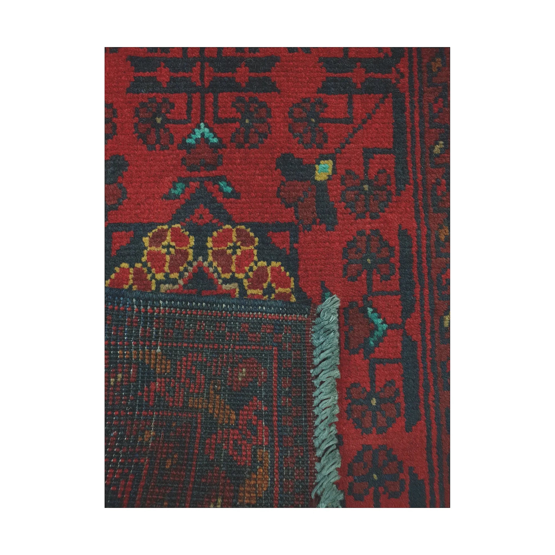 Folded corner reverse-weave detail of Afghan Khal Mohammadi hand-knotted wool rug showing back structure, fringe and border pattern