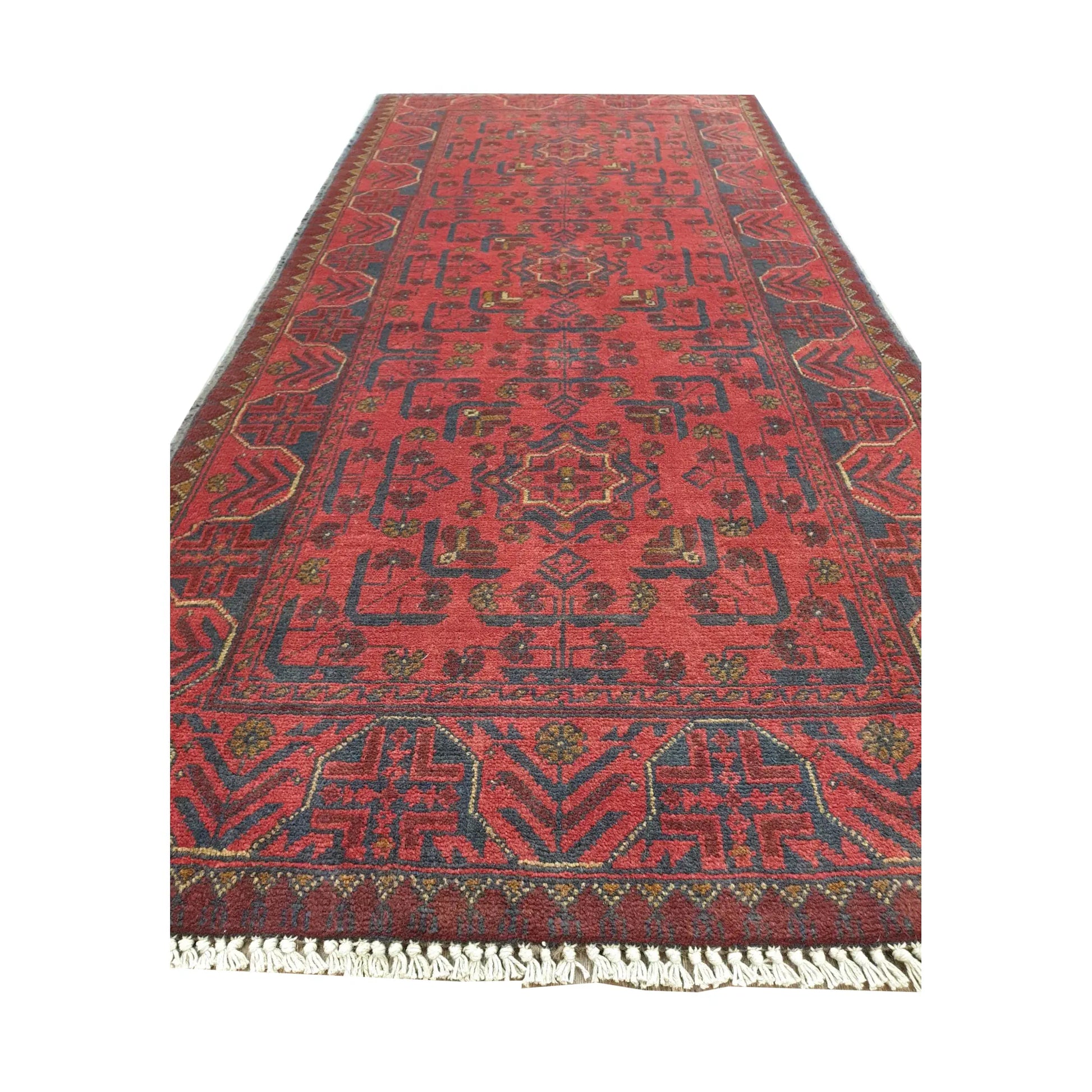 Angled full view of Afghan Khal Mohammadi wool runner rug showing red field, fringe and traditional geometric border