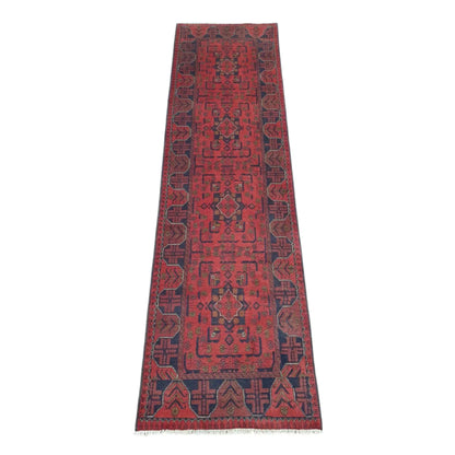 Full view of Afghan Khal Mohammadi hand-knotted wool runner rug with rich red field, repeating geometric medallions and deep navy border, 287 x 84 cm
