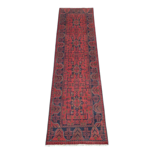 Full view of Afghan Khal Mohammadi hand-knotted wool runner rug with rich red field, repeating geometric medallions and deep navy border, 287 x 84 cm