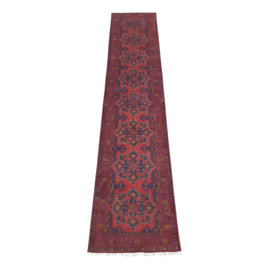 Full view of Afghan Khal Mohammadi hand-knotted wool runner rug with deep red field and repeating floral-geometric medallions, 385 x 80 cm