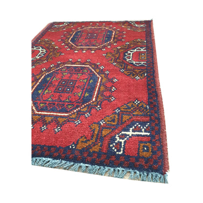 Fringe and border detail of Afghan Khal Mohammadi wool rug showing red pile, navy outlines and tribal motifs