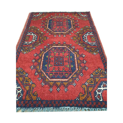 Afghan Khal Mohammadi wool rug detail showing paired octagonal medallion panels with ochre and ivory accents