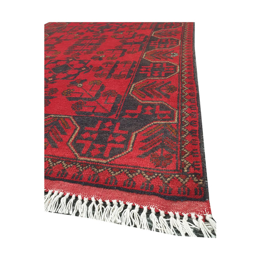 Angled fringe and edge detail of Afghan Khal Mohammadi rug showing wool texture, red field and dark border