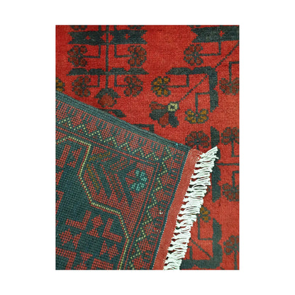 Folded corner detail of Afghan Khal Mohammadi rug showing the back of the rug, fringe and red front pattern