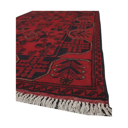Angled fringe and edge detail of Afghan Khal Mohammadi rug showing deep red wool pile and charcoal border pattern