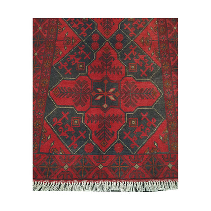 Central medallion and fringe detail of Afghan Khal Mohammadi rug with deep red field and charcoal tribal motifs