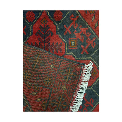 Folded corner detail of Afghan Khal Mohammadi rug showing the back of the rug, fringe and red front pattern