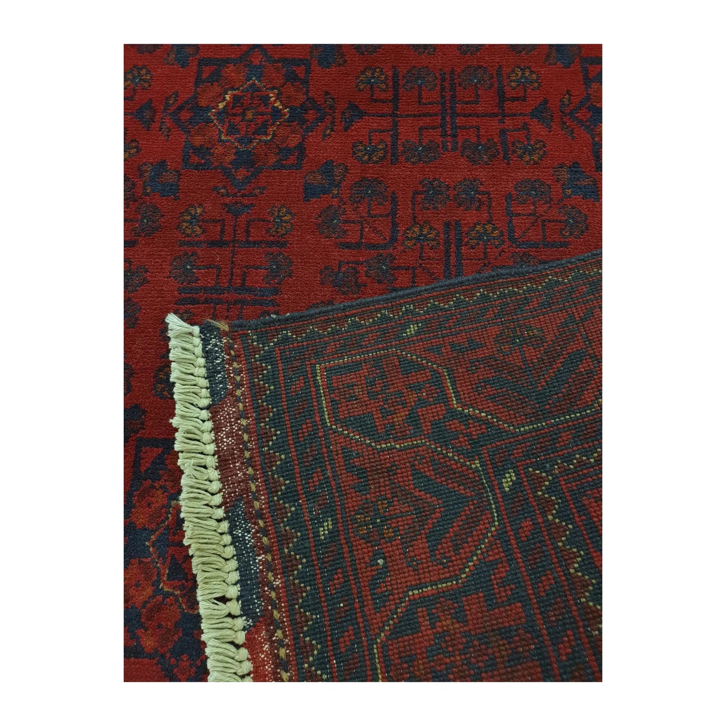 Folded-corner detail of Afghan Khal Mohammadi rug showing the patterned field, reverse weave and fringe