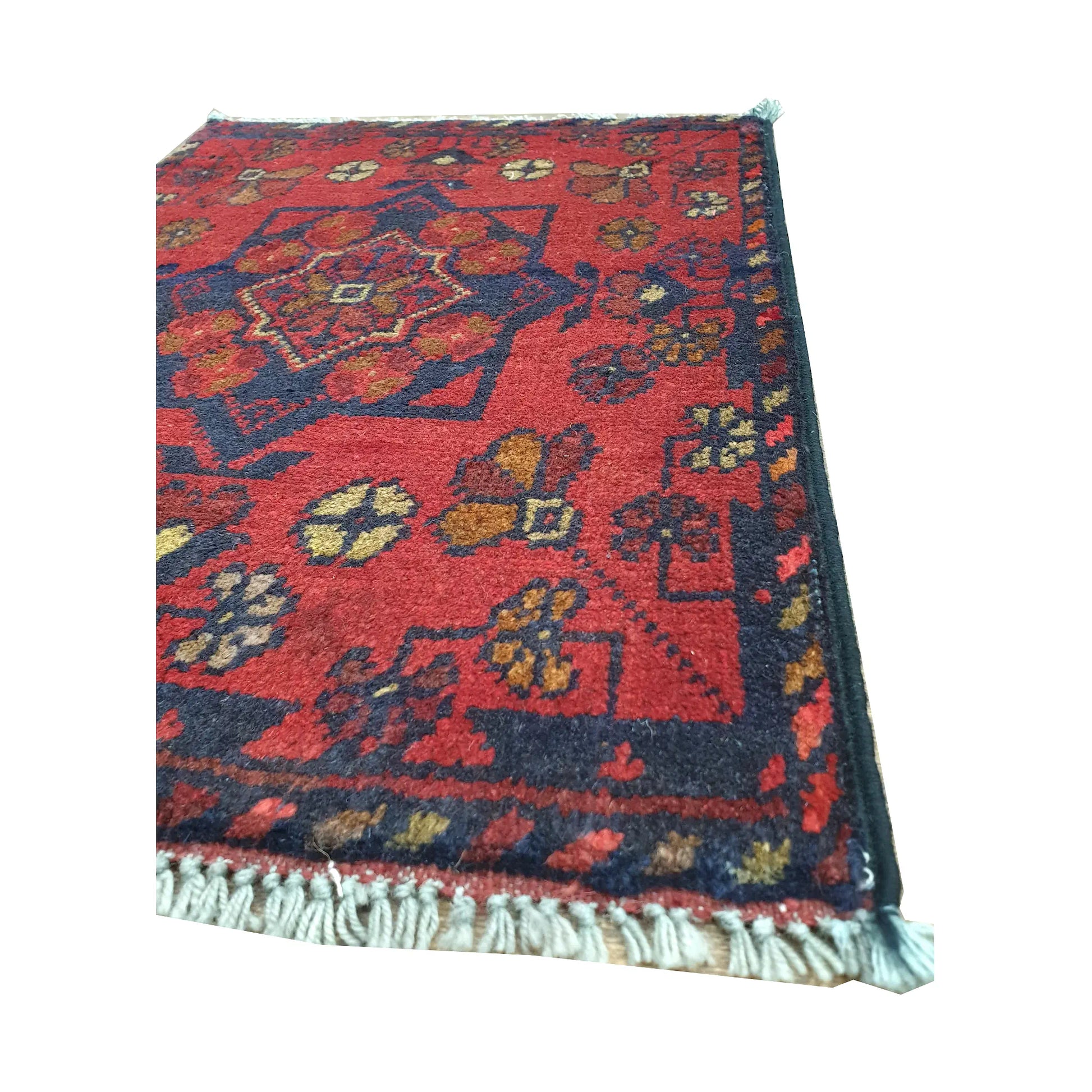 Fringe and border detail of Afghan Khal Mohammadi wool rug showing red field, dark edging and floral tribal motifs