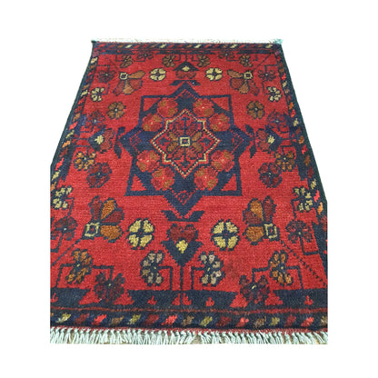 Afghan Khal Mohammadi wool rug detail showing red field, central medallion and traditional floral geometric pattern