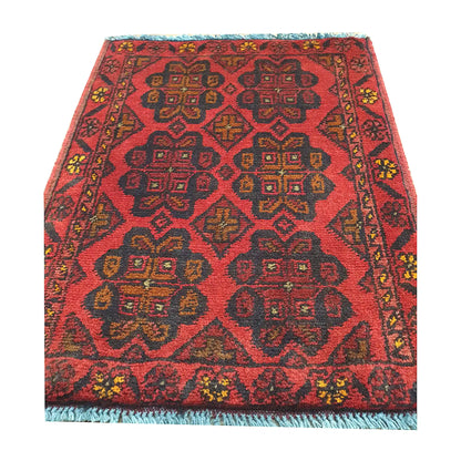 Afghan Khal Mohammadi wool rug detail showing red field with repeating floral geometric medallion pattern