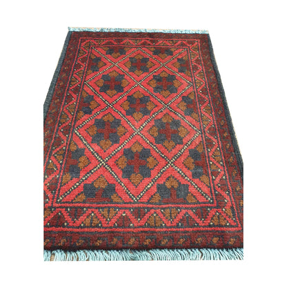 Afghan Khal Mohammadi wool rug detail showing red diamond lattice field with floral tribal motifs