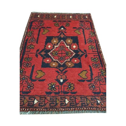 Afghan Khal Mohammadi wool rug detail showing central diamond medallion, red field and traditional tribal pattern