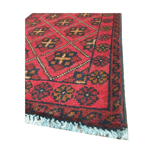Fringe and border detail of Afghan Khal Mohammadi wool rug showing red pile, dark edging and tribal motifs