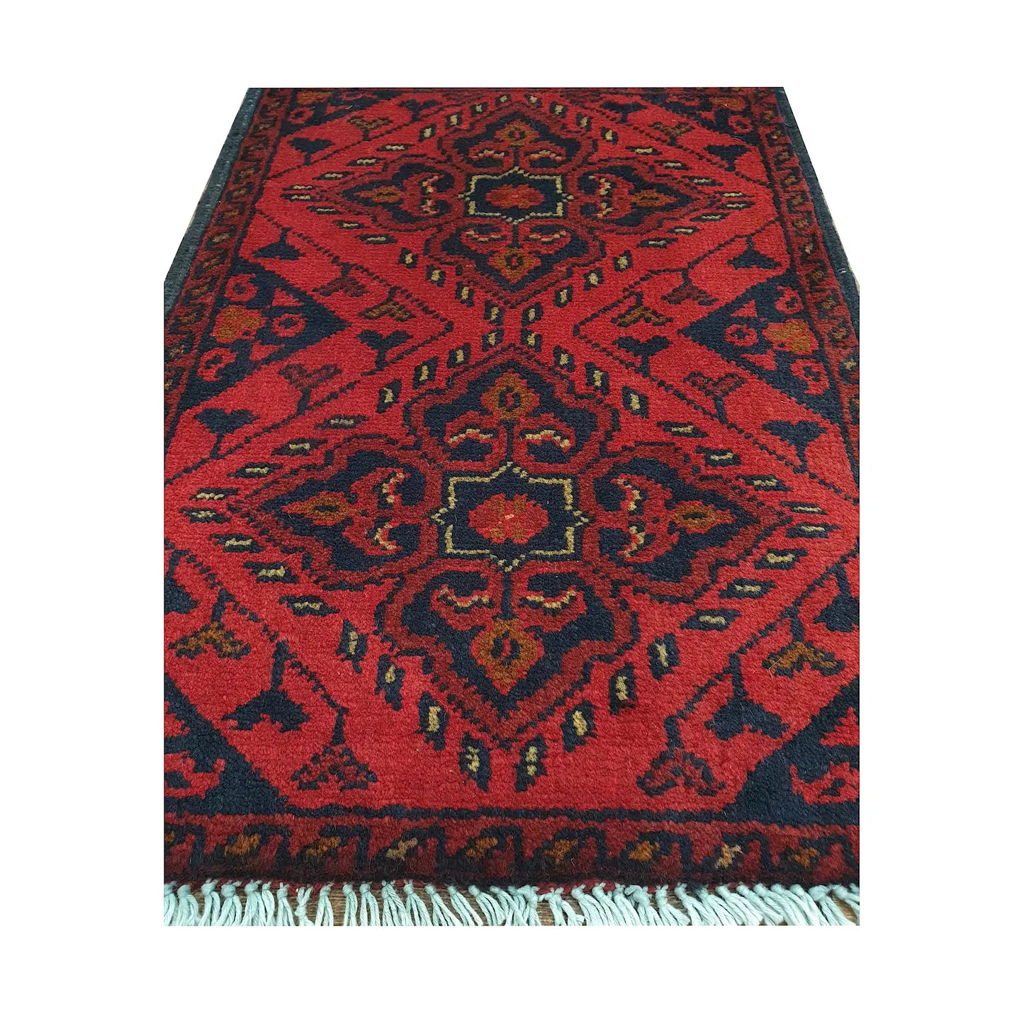Afghan Khal Mohammadi wool rug detail showing red tribal medallion pattern with ochre and ivory accents