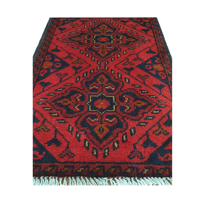 Afghan Khal Mohammadi wool rug detail showing red tribal medallion pattern with ochre and ivory accents