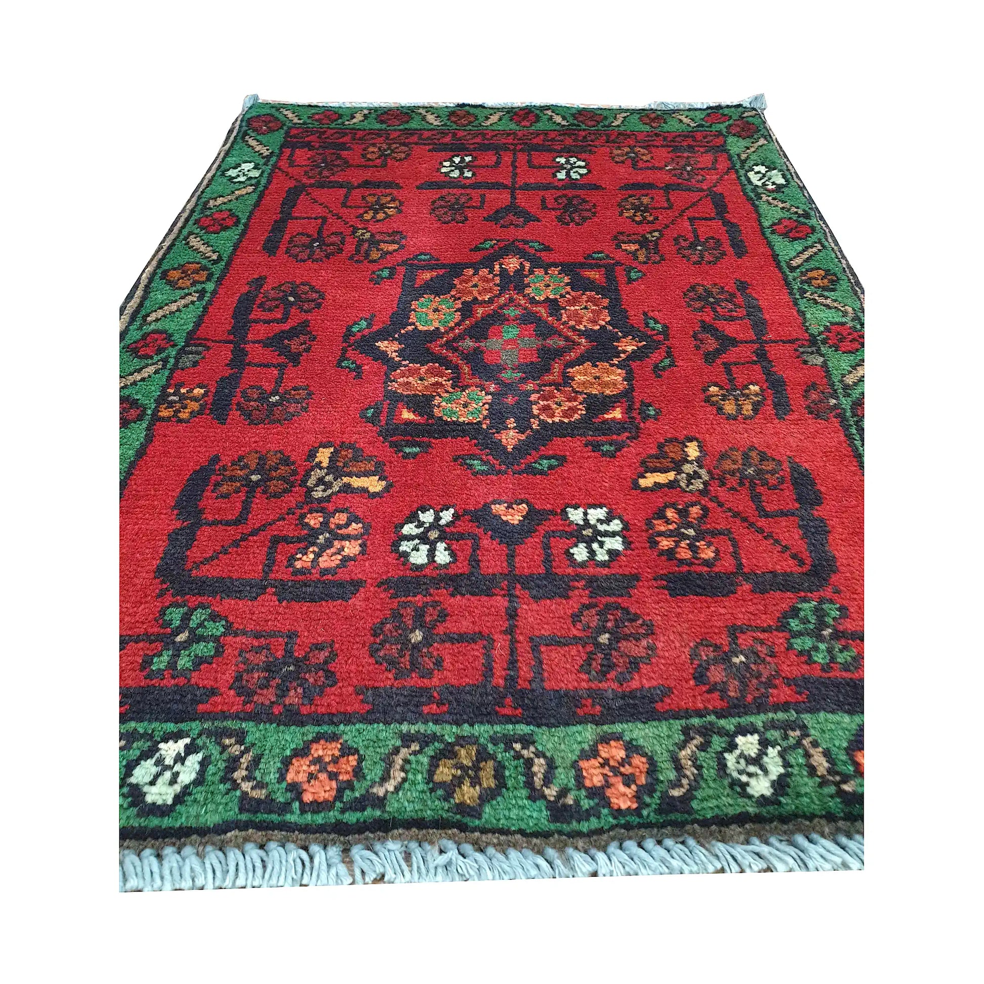 Afghan Khal Mohammadi wool rug detail showing red field, central floral medallion and scattered tribal motifs