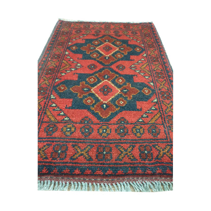 Afghan Khal Mohammadi wool rug detail showing three stepped diamond medallions with dark blue, ochre and ivory geometry