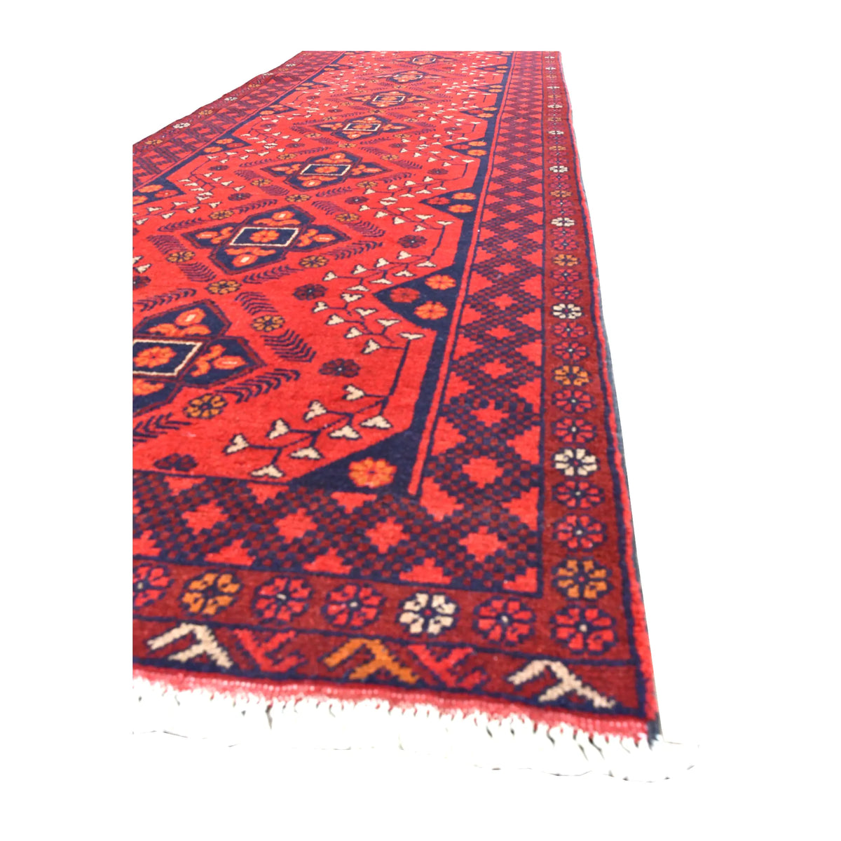 Angled view of Afghan Khal Mohammadi runner showing its deep red medallion field, layered geometric borders and white fringe