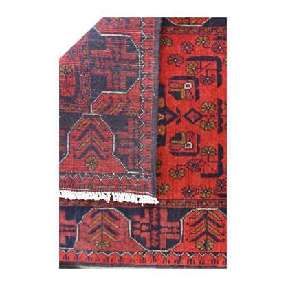 Folded-corner detail of Khal Mohammadi runner showing the reverse weave beside its deep red patterned front and white fringe