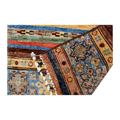 Folded corner and fringe detail of Afghan Khurjeen hand-knotted wool rug showing patterned bands, tassels and woven surface detail
