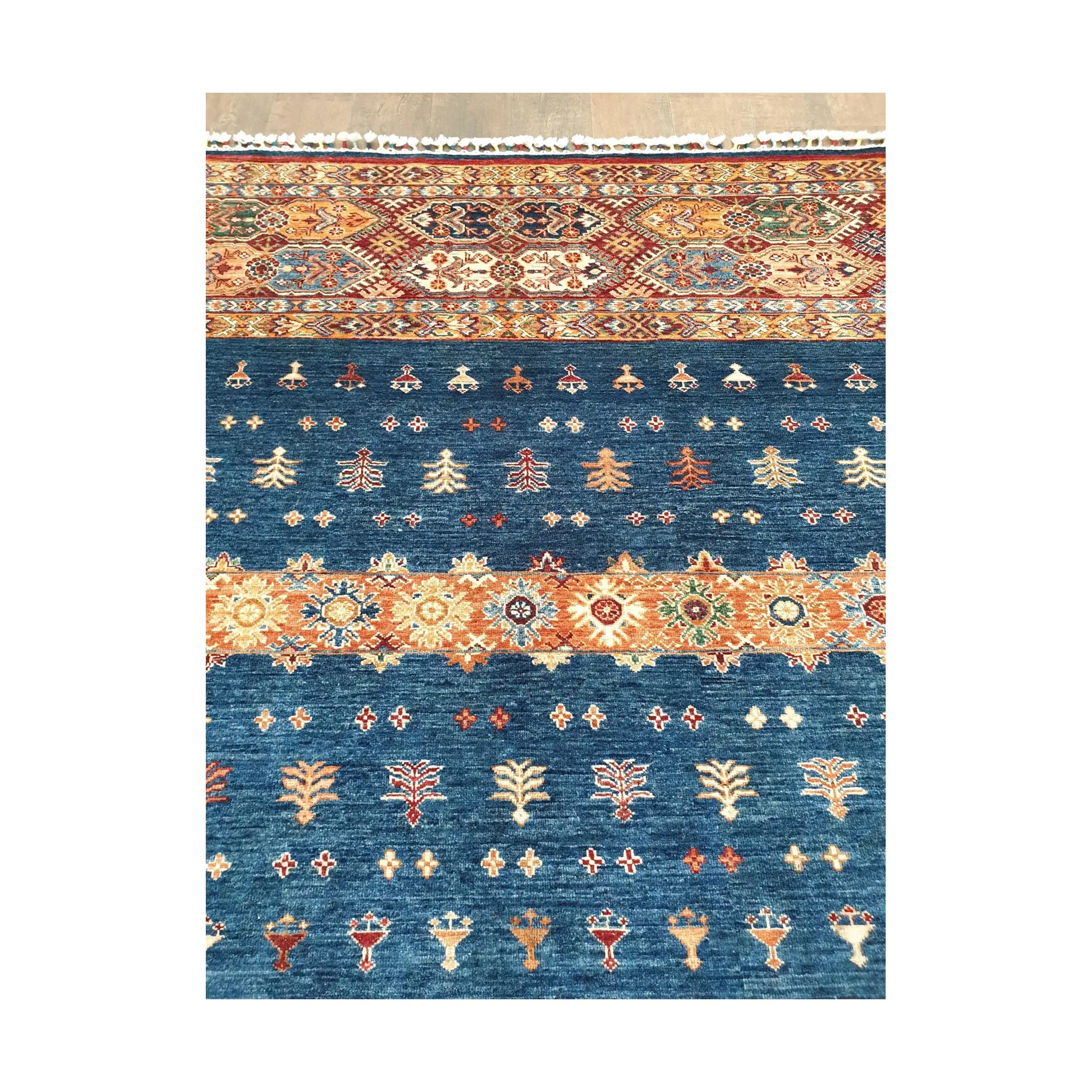 Blue field motif detail of Afghan Khurjeen wool rug with botanical tribal design