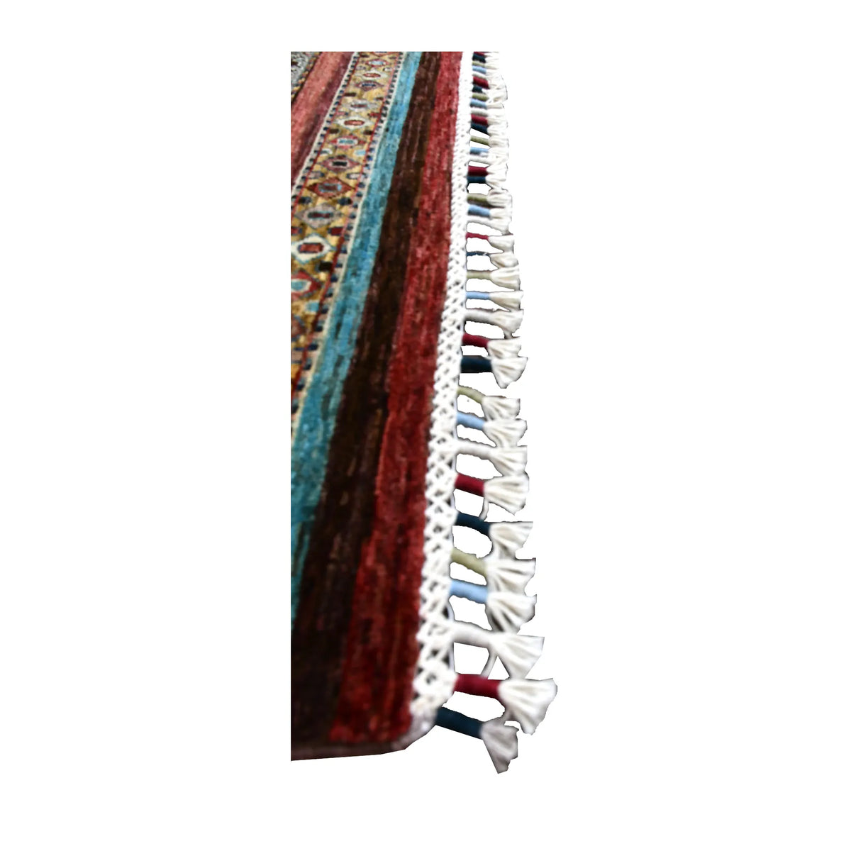 Side-edge detail of Khurjeen wool rug showing its pile, turquoise and rust-red stripes and knotted fringe