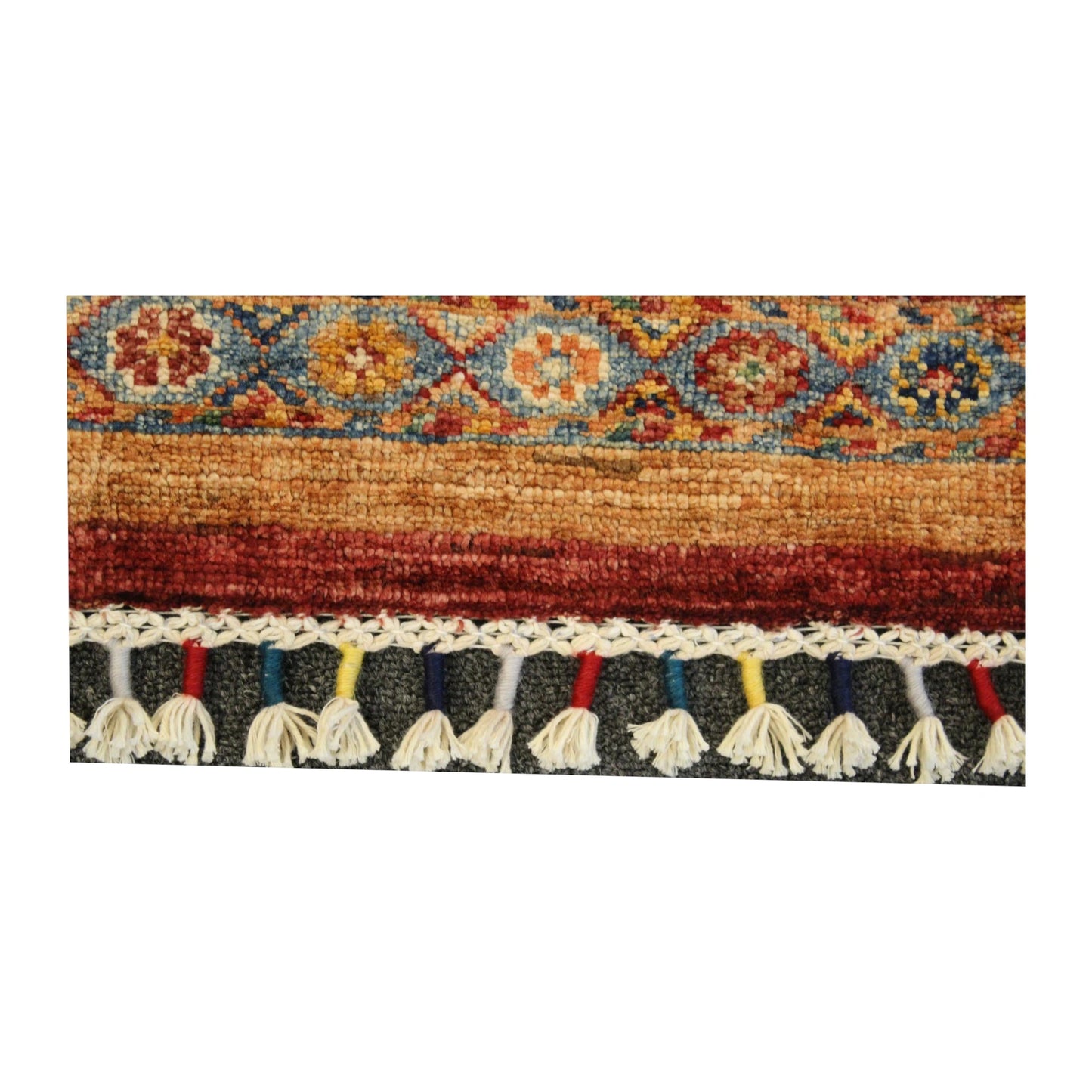 Close-up of Afghan Khurjeen rug showing the patterned end border and visible tassel fringe