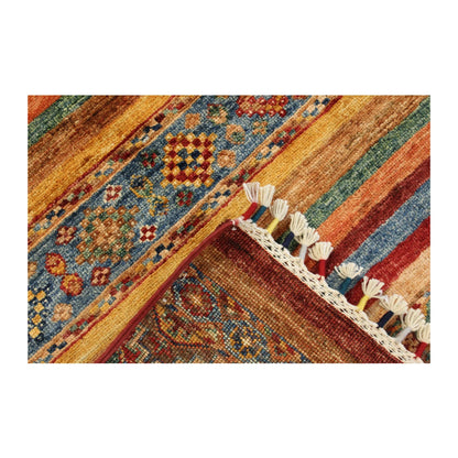 Folded-corner detail of Afghan Khurjeen rug showing the striped field, blue geometric band and tassel fringe