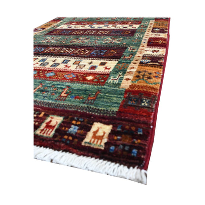 Angled fringe and edge detail of Afghan Khurjeen rug showing wool texture, teal field and multicolour panel pattern