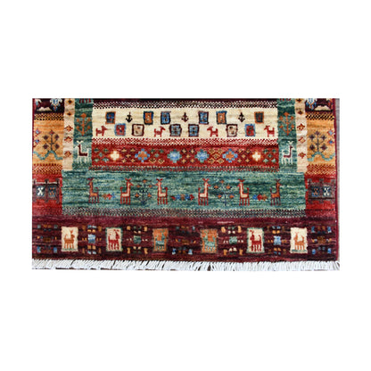 End panel and fringe detail of Afghan Khurjeen rug with teal field, burgundy border and ivory geometric motifs