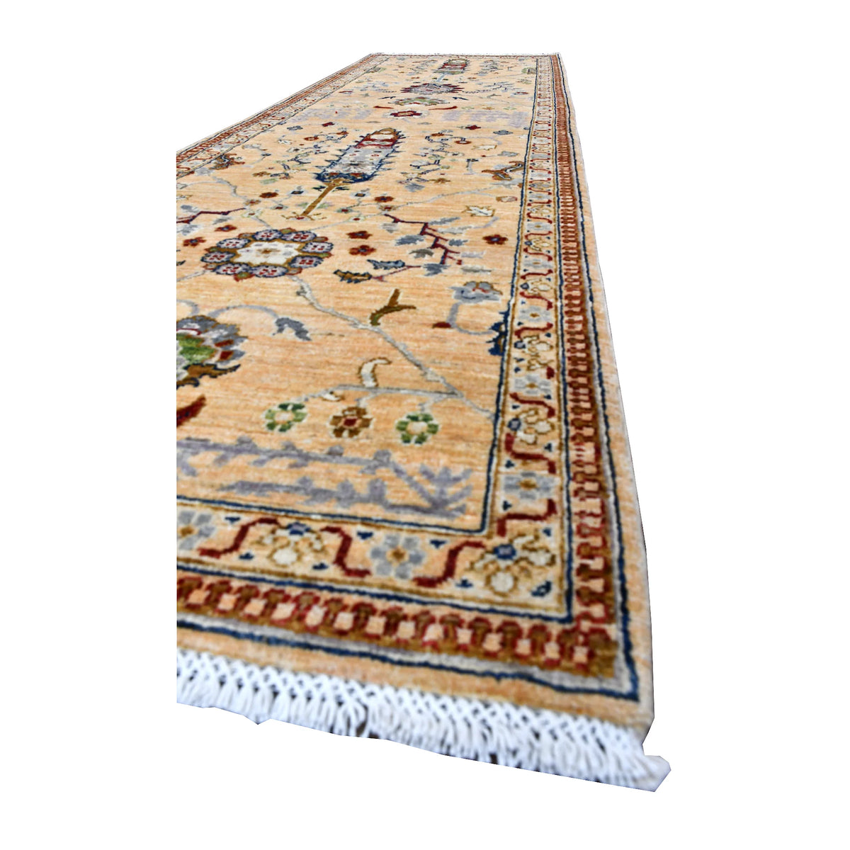 Angled view of Afghan Khurjeen runner showing its light floral field, muted blue vines, patterned borders and white fringe