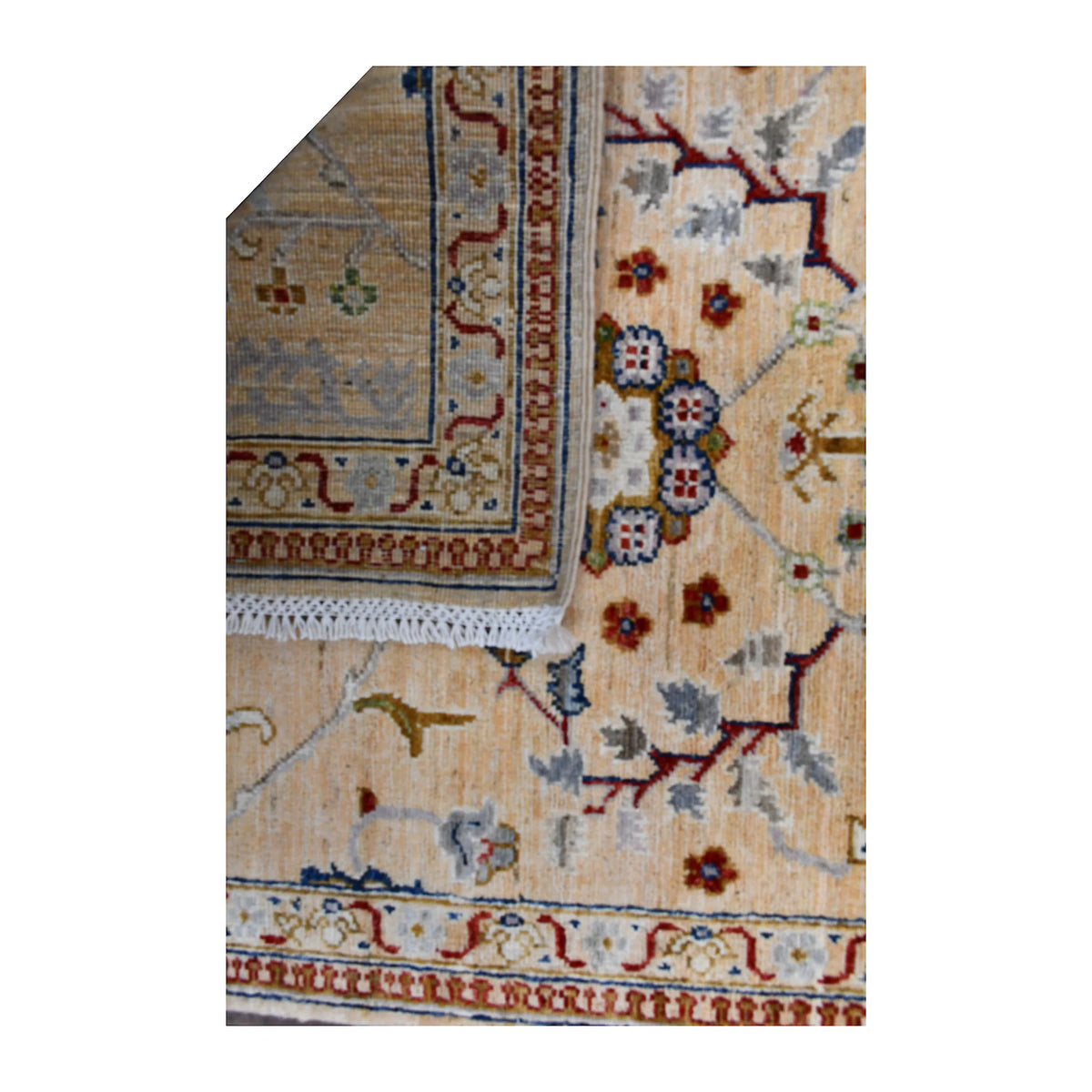 Folded-corner detail of Afghan Khurjeen runner showing the reverse weave beside its ivory-beige patterned front