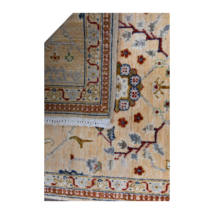 Folded-corner detail of Afghan Khurjeen runner showing the reverse weave beside its ivory-beige patterned front