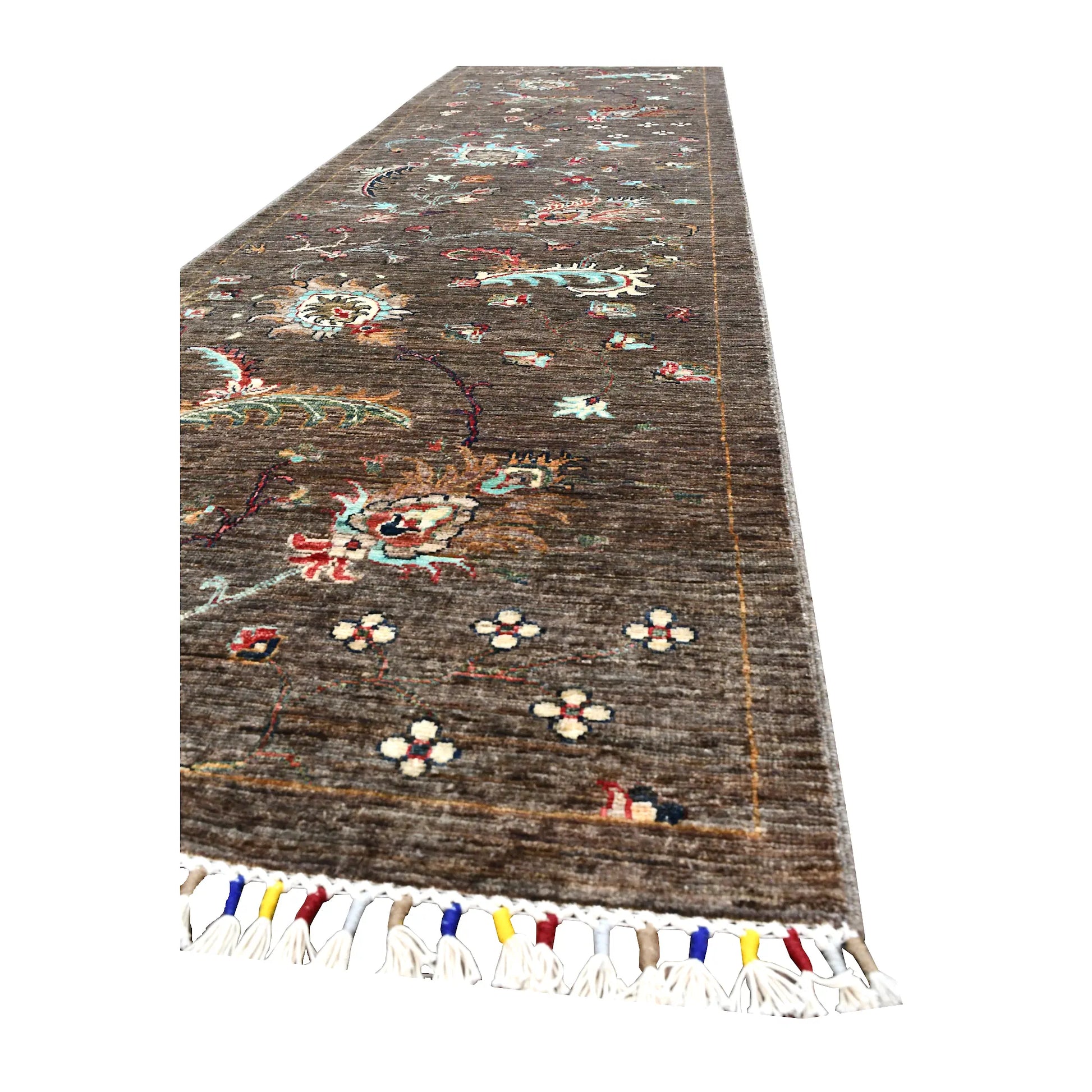 Angled end view of Afghan Khurjeen runner showing its brown field, botanical motifs and multicoloured fringe