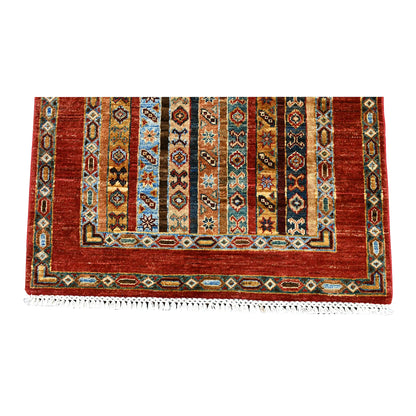 Overhead end section of Afghan Khurjeen runner showing geometric stripes, layered borders and fringe