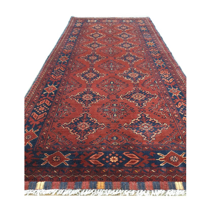 Angled fringe detail of Afghan Kunduz wool runner rug showing red field, dark border and hand-knotted texture