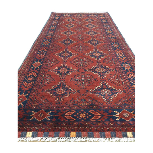 Angled fringe detail of Afghan Kunduz wool runner rug showing red field, dark border and hand-knotted texture