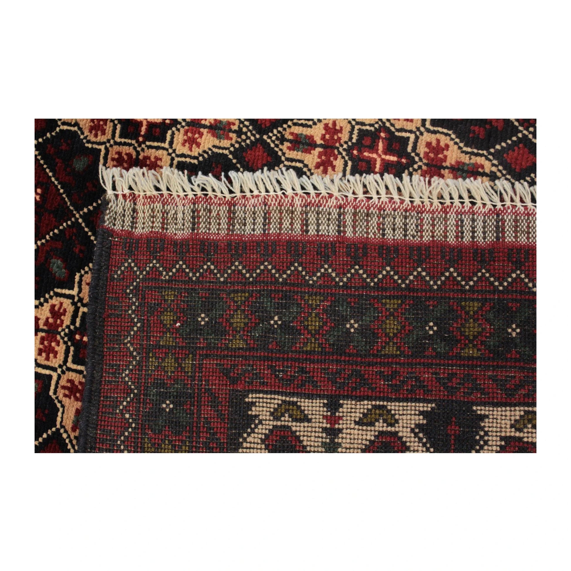 Reverse-weave end detail of Afghan Kunduz rug showing the handmade structure, flatwoven band and fringe