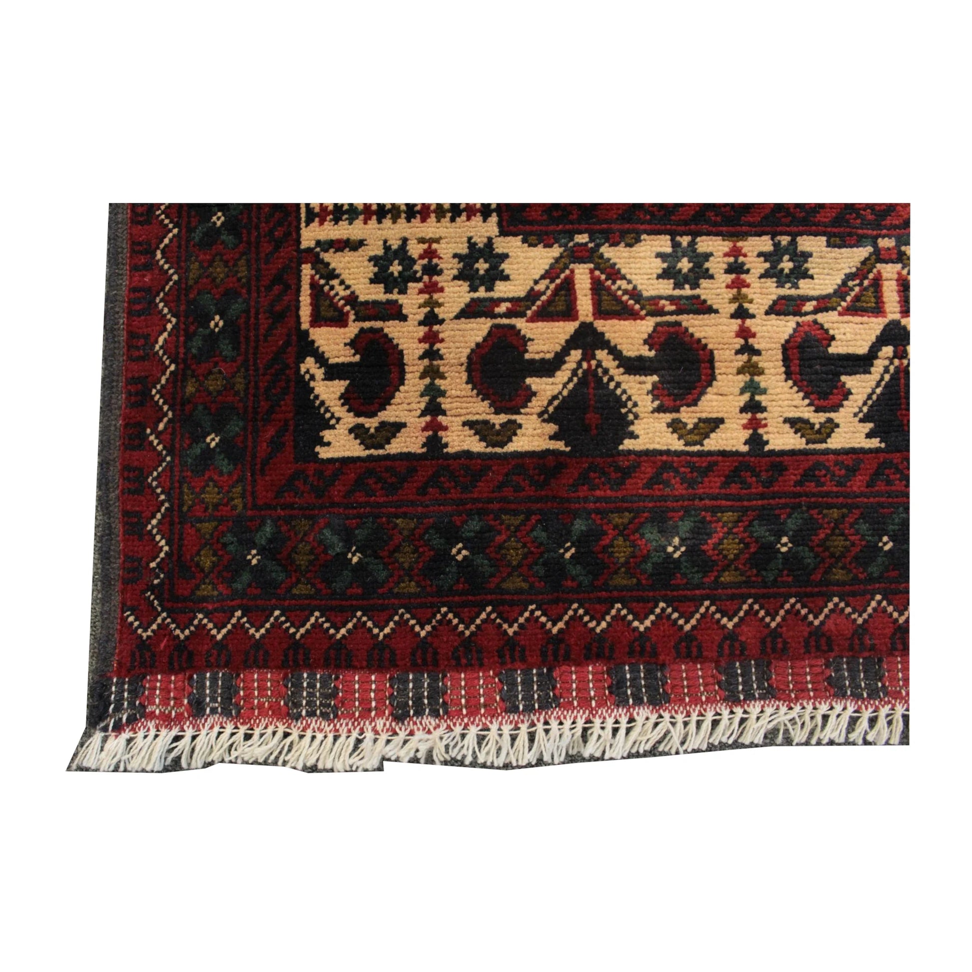 Straight-on end detail of Afghan Kunduz rug showing the patterned border and visible fringe