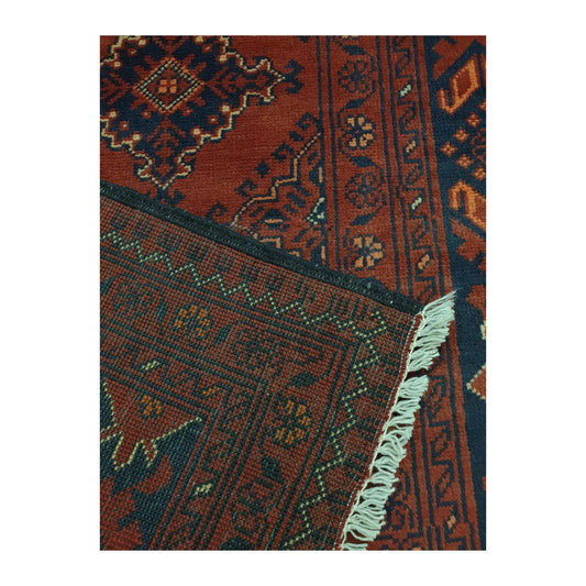 Folded-corner detail of Afghan Kunduz runner rug showing wool pile, reverse weave, layered border and fringe