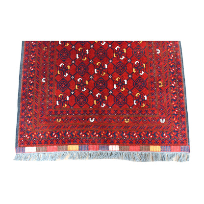 Fringe-end detail of Afghan Kunduz runner showing the diamond lattice, red and navy borders and blue-grey fringe
