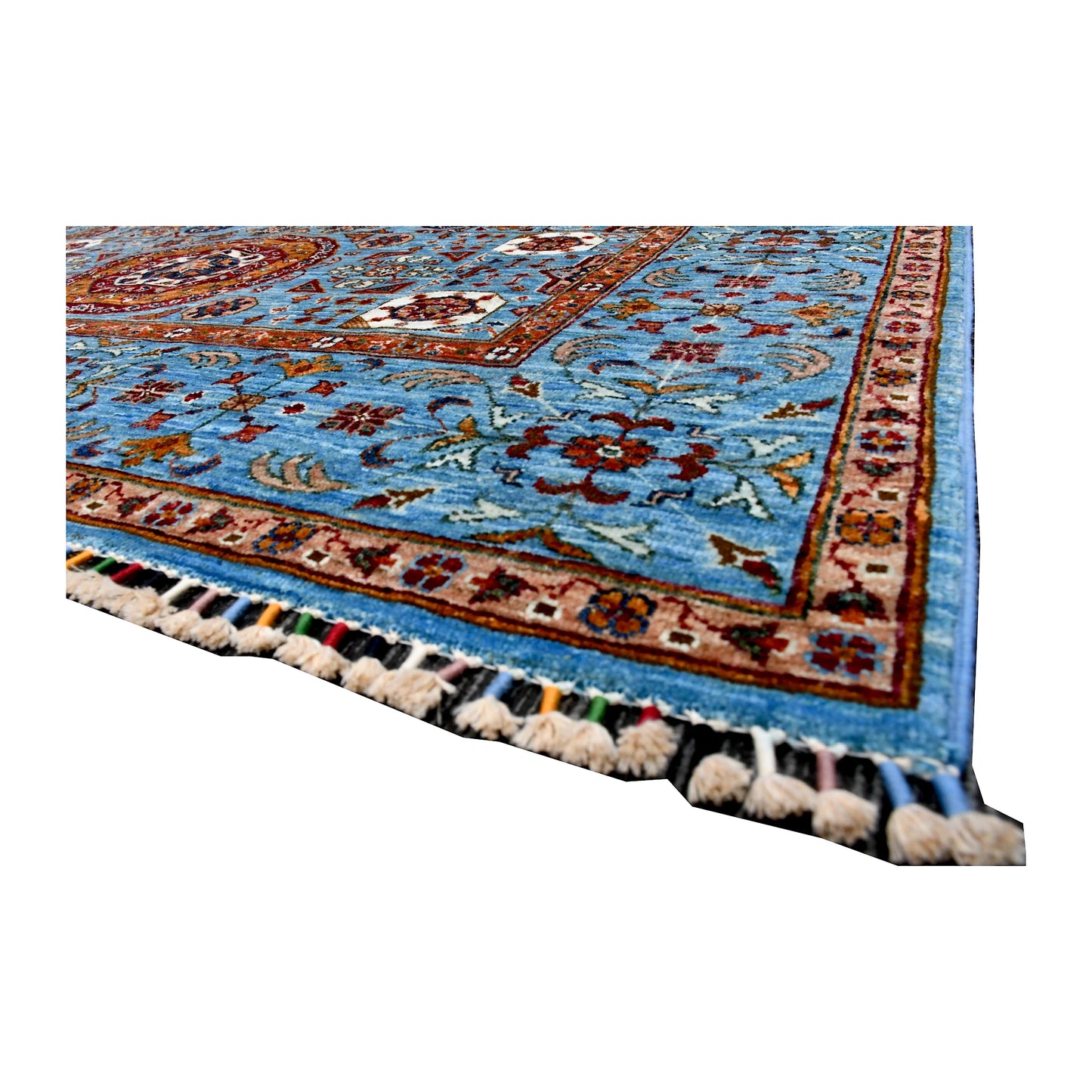 Angled corner and fringe view of Afghan Mamluk wool rug showing sky-blue field, rust border detail and tassel fringe
