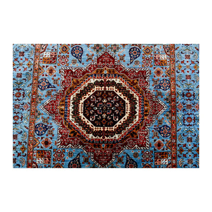 Central medallion and field detail of Afghan Mamluk wool rug showing sky-blue ground, rust red medallion and geometric-floral motifs